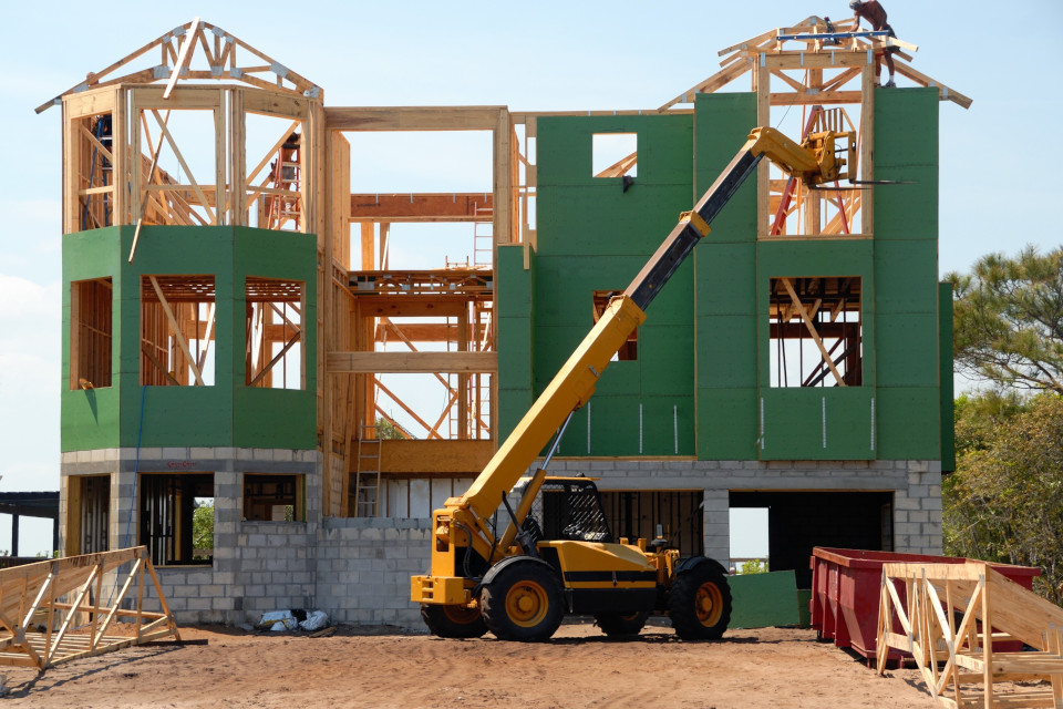 crew erecting framing and installing exterior insulation